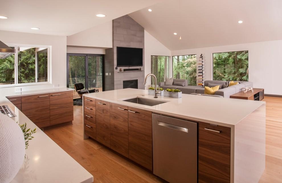 Open-plan kitchen with walnut island and vaulted ceiling remodeled by Pro Floors and Walls