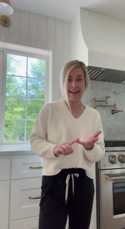 Homeowner in her finished kitchen sharing her remodel experience