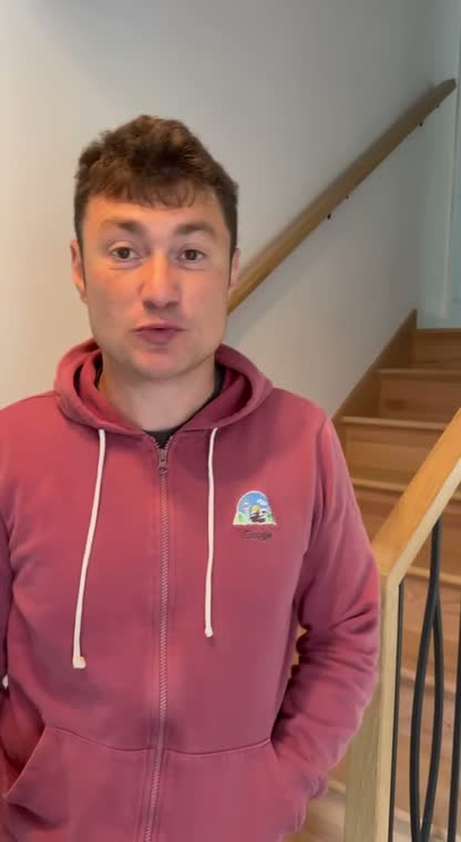 Homeowner by his new staircase sharing his remodel experience