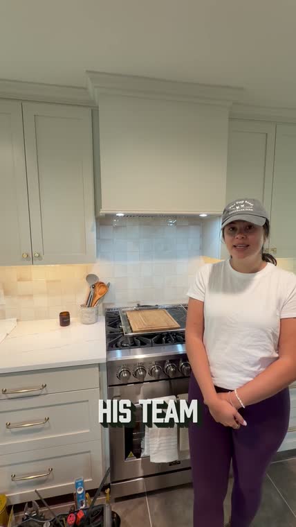 Homeowner in her remodeled kitchen sharing her experience